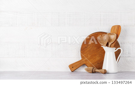 Kitchen utensils and cutting boards on table 133497264