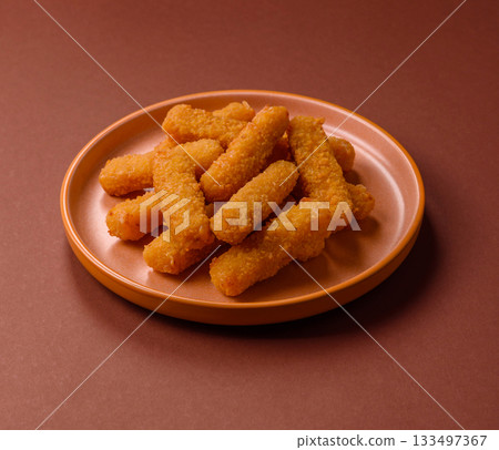 Mozzarella cheese sticks, crispy nutritious fast food. Cheese sticks as food background Mozzarella cheese sticks, crispy nutritious fast food. Cheese sticks as food background 133497367