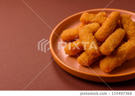 Mozzarella cheese sticks, crispy nutritious fast food. Cheese sticks as food background Mozzarella cheese sticks, crispy nutritious fast food. Cheese sticks as food background 133497368