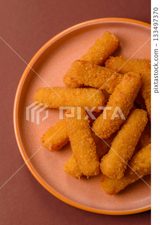 Mozzarella cheese sticks, crispy nutritious fast food. Cheese sticks as food background 133497370