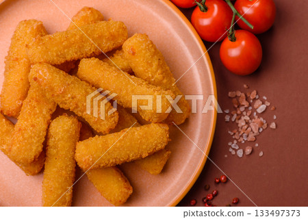 Mozzarella cheese sticks, crispy nutritious fast food. Cheese sticks as food background Mozzarella cheese sticks, crispy nutritious fast food. Cheese sticks as food background 133497373