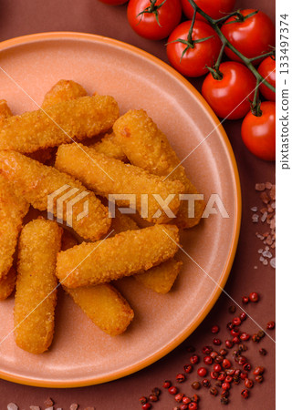 Mozzarella cheese sticks, crispy nutritious fast food. Cheese sticks as food background Mozzarella cheese sticks, crispy nutritious fast food. Cheese sticks as food background 133497374