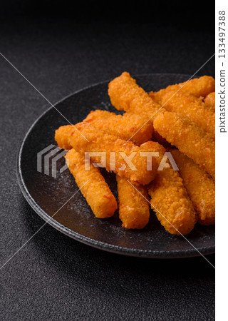 Mozzarella cheese sticks, crispy nutritious fast food. Cheese sticks as food background Mozzarella cheese sticks, crispy nutritious fast food. Cheese sticks as food background 133497388