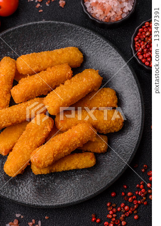 Mozzarella cheese sticks, crispy nutritious fast food. Cheese sticks as food background Mozzarella cheese sticks, crispy nutritious fast food. Cheese sticks as food background 133497391