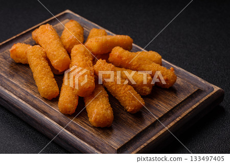 Mozzarella cheese sticks, crispy nutritious fast food. Cheese sticks as food background Mozzarella cheese sticks, crispy nutritious fast food. Cheese sticks as food background 133497405