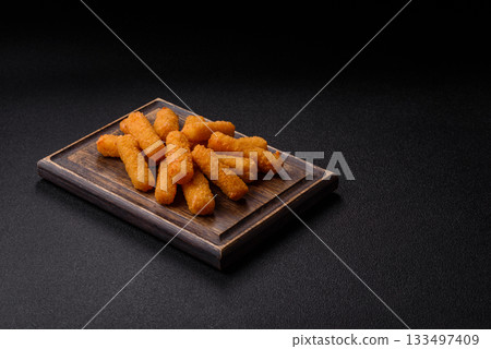 Mozzarella cheese sticks, crispy nutritious fast food. Cheese sticks as food background Mozzarella cheese sticks, crispy nutritious fast food. Cheese sticks as food background 133497409
