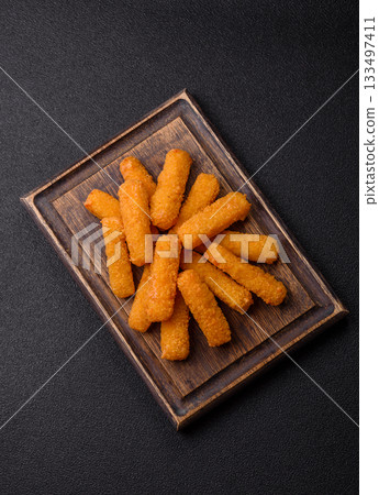 Mozzarella cheese sticks, crispy nutritious fast food. Cheese sticks as food background Mozzarella cheese sticks, crispy nutritious fast food. Cheese sticks as food background 133497411