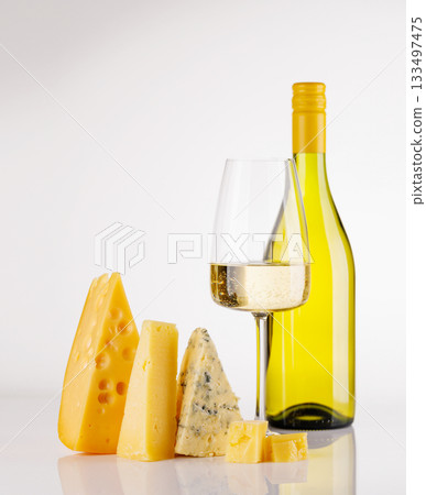 Assorted cheeses and wine bottle on white background Assorted cheeses and wine bottle on white background 133497475