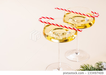 Champagne glasses and snowy fir branches Champagne glasses and snowy fir branches 133497489