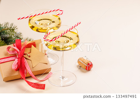 Champagne glasses and snowy fir branches 133497491