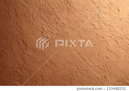 Textured clay wall surface in warm earth tones 133498232