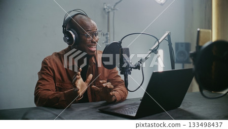 Man Sits at Laptop and Records Professional Dubbing Man Sits at Laptop and Records Professional Dubbing 133498437