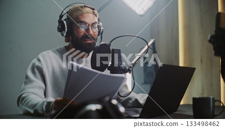 Professional Male Podcast Host Recording Episode in Studio Professional Male Podcast Host Recording Episode in Studio 133498462