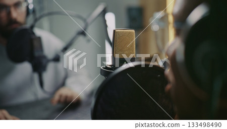 Professional Podcast Recording Session With Two Male, Hosts and Guest, Capturing Audio in Studio 133498490