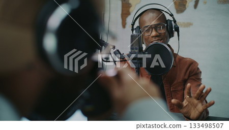Candid Podcast Conversation Between Two Men in Creative Studio Candid Podcast Conversation Between Two Men in Creative Studio 133498507
