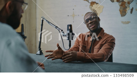 Smiling Podcast Guest Sharing Insights During Relaxed Studio Talk 133498509