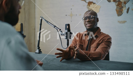 Smiling Podcast Guest Sharing Insights During Relaxed Studio Talk 133498511