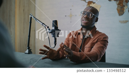 Confident Podcast Guest Engaged in Thoughtful Studio Discussion 133498512