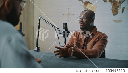 Smiling Podcast Guest Sharing Insights During Relaxed Studio Talk 133498513