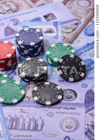 Casino game in the United Arab Emirates, dirham, chips, cards. Gambling in casinos in the Emirates Casino game in the United Arab Emirates, dirham, chips, cards. Gambling in casinos in the Emirates 133498609