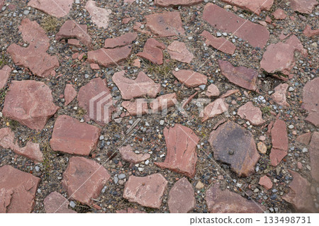 Old red cobblestones, ancient pavement with uneven brown stones Old red cobblestones, ancient pavement with uneven brown stones 133498731