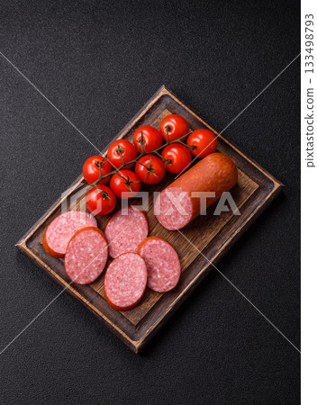 Sliced salami sausage, smoked dry meat as food background. Sliced salami 133498793