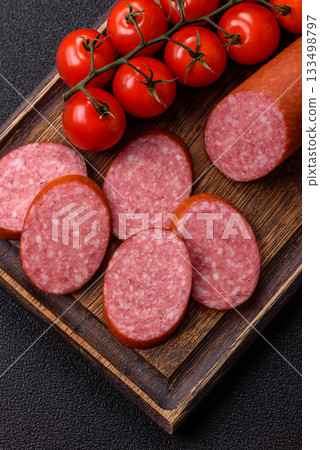 Sliced salami sausage, smoked dry meat as food background. Sliced salami 133498797
