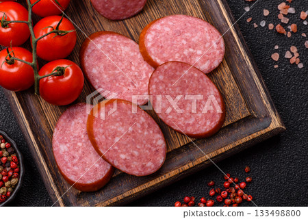 Sliced salami sausage, smoked dry meat as food background. Sliced salami 133498800