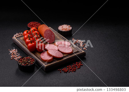Sliced salami sausage, smoked dry meat as food background. Sliced salami 133498803