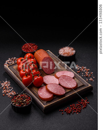 Sliced salami sausage, smoked dry meat as food background. Sliced salami 133498806