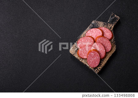 Sliced salami sausage, smoked dry meat as food background. Sliced salami 133498808