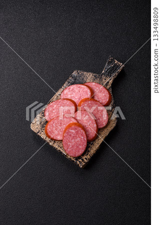 Sliced salami sausage, smoked dry meat as food background. Sliced salami Sliced salami sausage, smoked dry meat as food background. Sliced salami 133498809