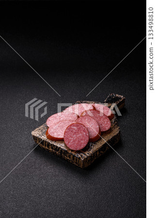 Sliced salami sausage, smoked dry meat as food background. Sliced salami 133498810