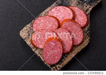 Sliced salami sausage, smoked dry meat as food background. Sliced salami Sliced salami sausage, smoked dry meat as food background. Sliced salami 133498812
