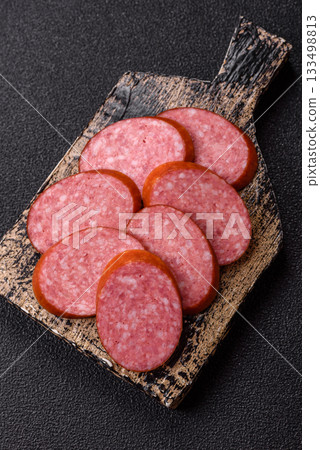 Sliced salami sausage, smoked dry meat as food background. Sliced salami 133498813