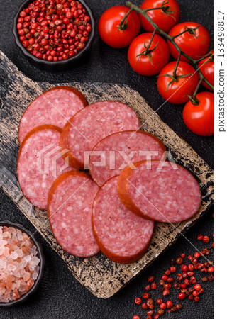Sliced salami sausage, smoked dry meat as food background. Sliced salami 133498817