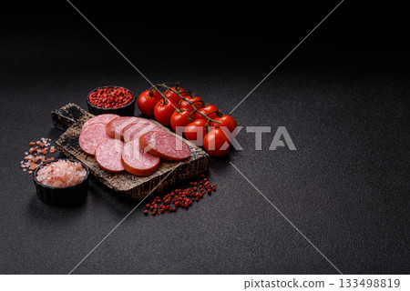 Sliced salami sausage, smoked dry meat as food background. Sliced salami 133498819