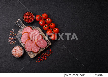 Sliced salami sausage, smoked dry meat as food background. Sliced salami 133498820
