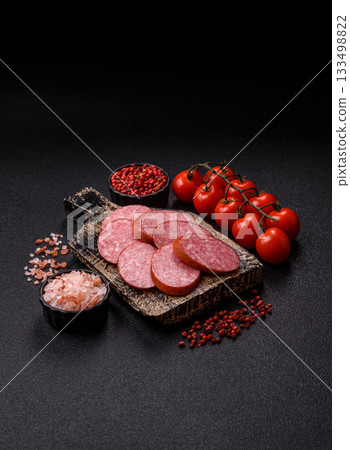 Sliced salami sausage, smoked dry meat as food background. Sliced salami 133498822