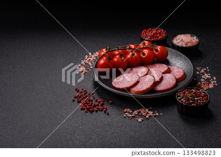 Sliced salami sausage, smoked dry meat as food background. Sliced salami 133498823