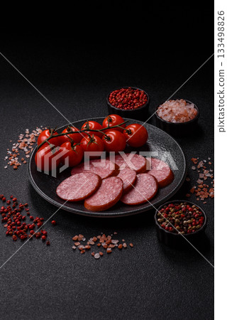 Sliced salami sausage, smoked dry meat as food background. Sliced salami 133498826