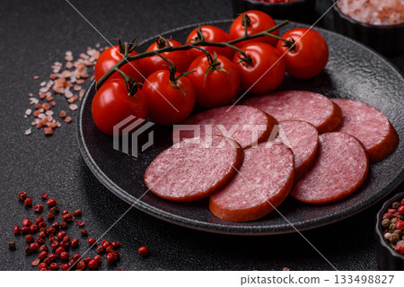 Sliced salami sausage, smoked dry meat as food background. Sliced salami 133498827