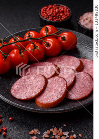 Sliced salami sausage, smoked dry meat as food background. Sliced salami 133498830