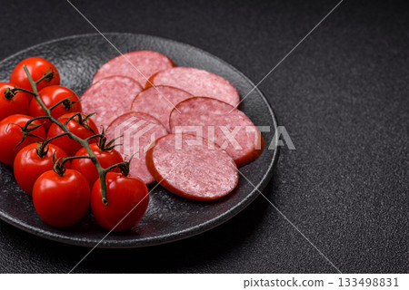 Sliced salami sausage, smoked dry meat as food background. Sliced salami 133498831