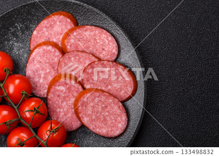 Sliced salami sausage, smoked dry meat as food background. Sliced salami Sliced salami sausage, smoked dry meat as food background. Sliced salami 133498832