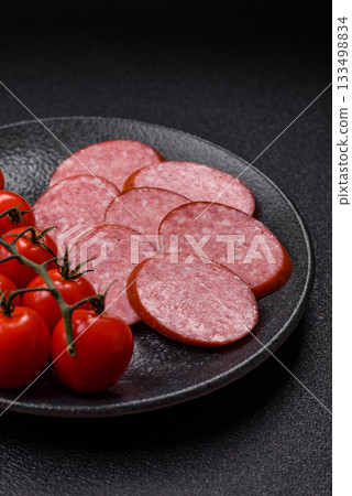 Sliced salami sausage, smoked dry meat as food background. Sliced salami Sliced salami sausage, smoked dry meat as food background. Sliced salami 133498834