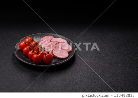 Sliced salami sausage, smoked dry meat as food background. Sliced salami 133498835