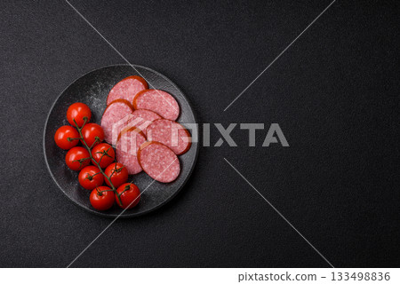 Sliced salami sausage, smoked dry meat as food background. Sliced salami 133498836