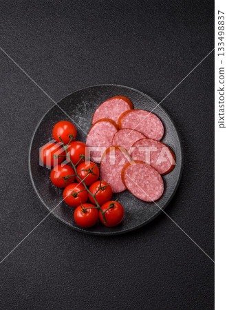 Sliced salami sausage, smoked dry meat as food background. Sliced salami 133498837