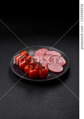 Sliced salami sausage, smoked dry meat as food background. Sliced salami 133498838
